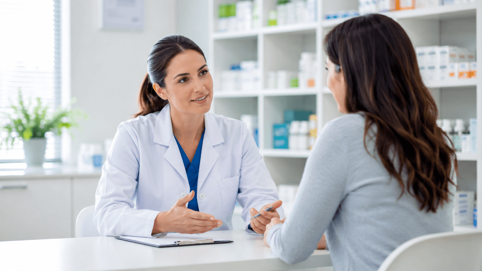 Consultation between a female clinician and patient in a bright, non-branded pharmacy setting.